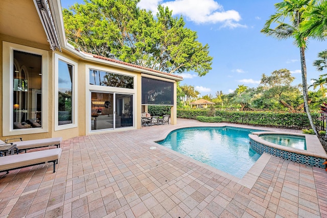 view of pool with an in ground hot tub and a patio