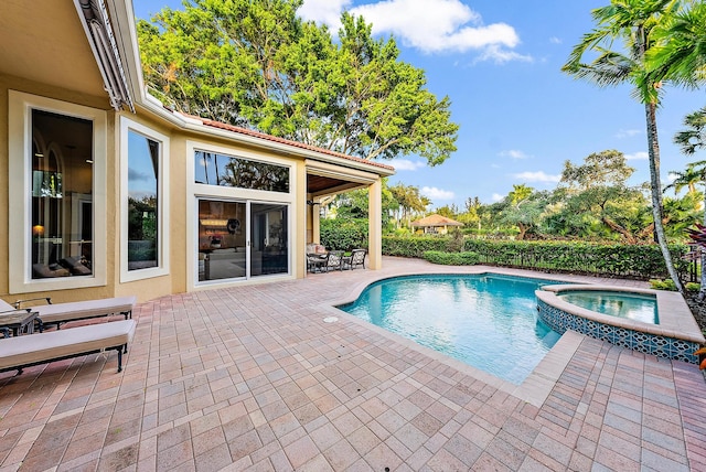 view of pool featuring a patio area and an in ground hot tub