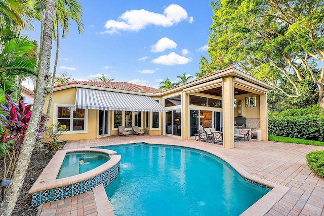 view of swimming pool featuring an in ground hot tub and a patio area