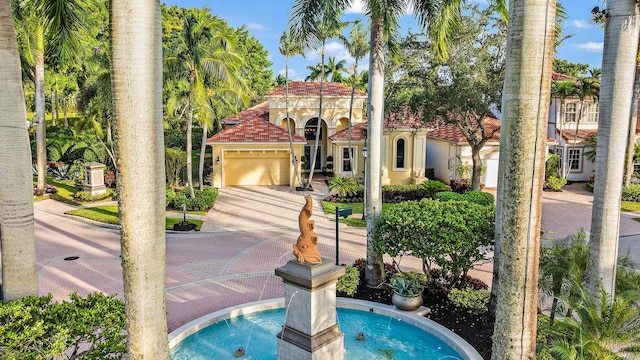 7190 Tradition Cove Ln E, West Palm Beach, FL 33412 - view of front of home with concrete driveway, an attached garage, stucco siding, and a tile roof