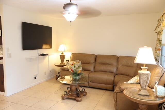 tiled living room with ceiling fan