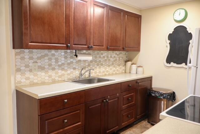 kitchen with decorative backsplash, sink, and stove