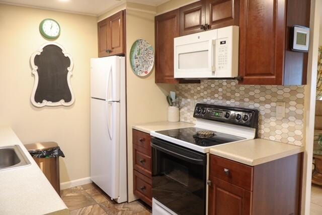 kitchen with white appliances and backsplash