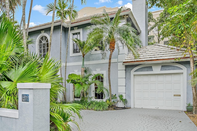 view of front of house featuring decorative driveway and stucco siding