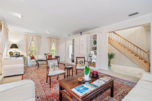 living room with visible vents, baseboards, ornamental molding, and stairs