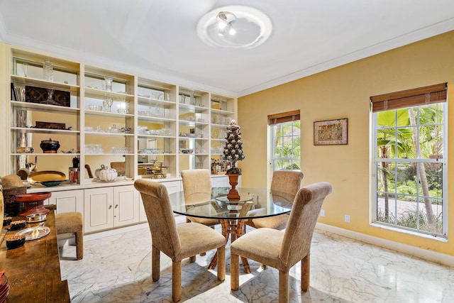 dining room featuring marble finish floor, crown molding, and baseboards