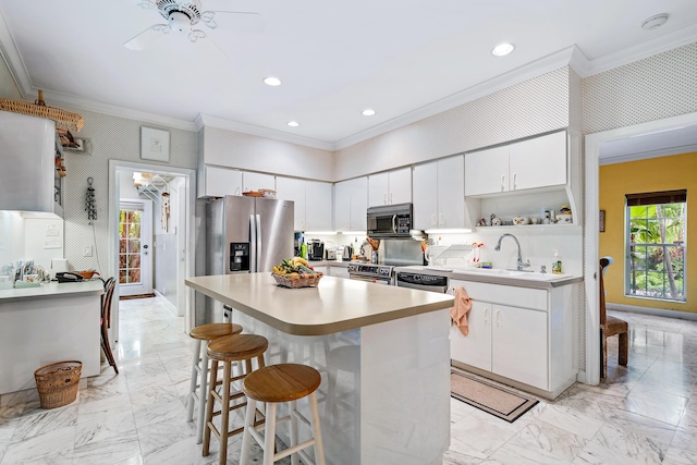 kitchen with a sink, stainless steel appliances, marble finish floor, and ornamental molding