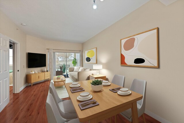 living room featuring wood-type flooring and a textured ceiling