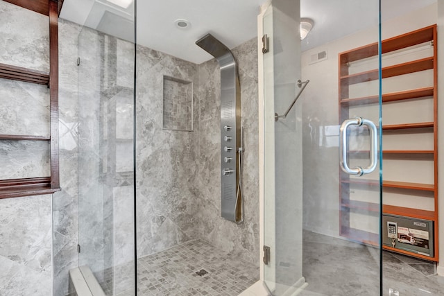 bathroom with a shower with shower door