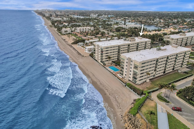 birds eye view of property featuring a water view and a view of the beach