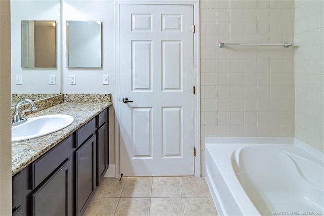 bathroom with tile patterned flooring, vanity, and a tub