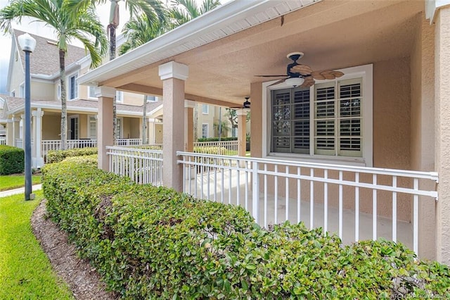 view of side of property featuring a porch and ceiling fan