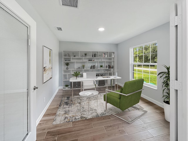 sitting room with wood-type flooring