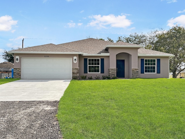 view of front of home featuring a front yard and a garage