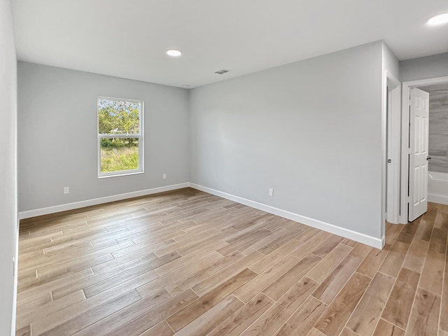 spare room with light wood-type flooring