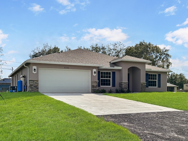 view of front of property featuring a garage and a front lawn