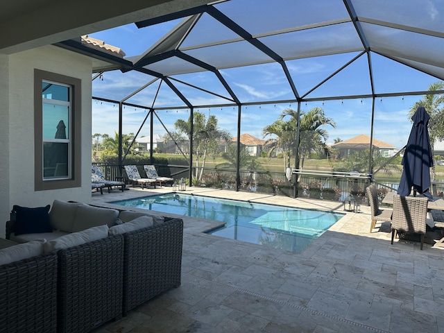 view of swimming pool with a patio, an outdoor hangout area, and glass enclosure