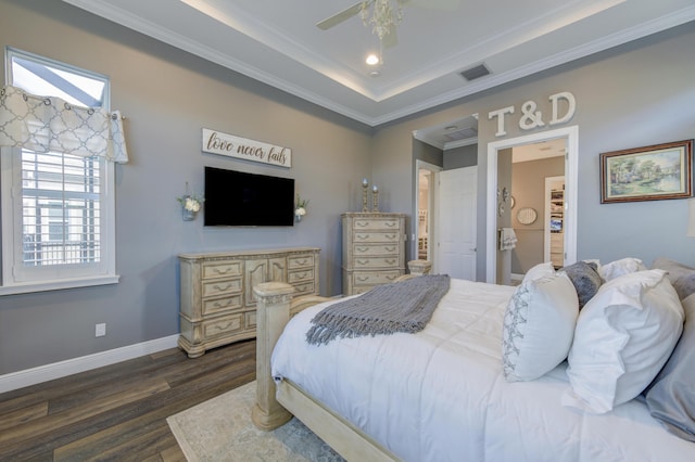 bedroom with crown molding, dark hardwood / wood-style floors, ceiling fan, and a tray ceiling