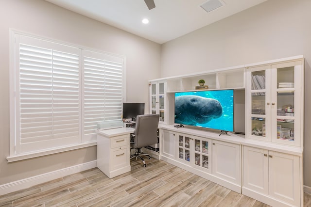 home office with ceiling fan and light hardwood / wood-style flooring