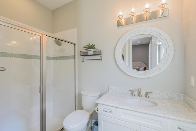 bathroom featuring vanity, toilet, and an enclosed shower