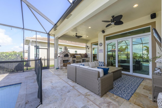 view of patio featuring ceiling fan, an outdoor living space with a fireplace, and area for grilling