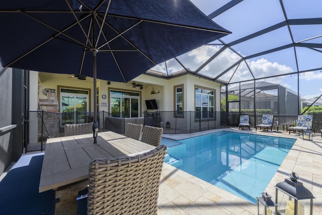 view of pool featuring ceiling fan, a lanai, and a patio