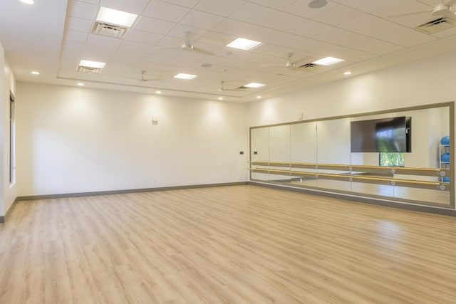 interior space featuring a paneled ceiling and light wood-type flooring