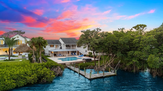 dock area featuring a balcony, a water view, and a patio area