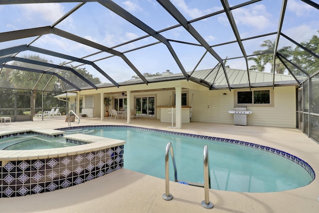 view of swimming pool with an in ground hot tub, area for grilling, a lanai, ceiling fan, and a patio area