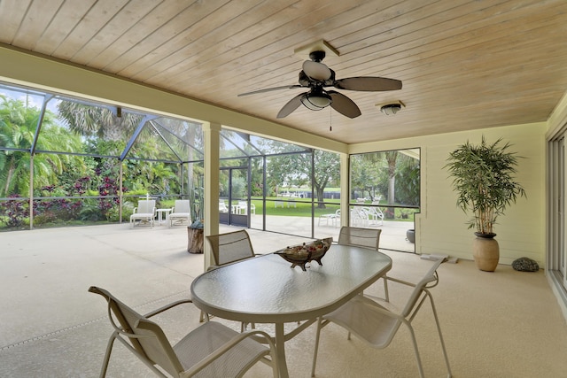 sunroom / solarium with ceiling fan and wooden ceiling