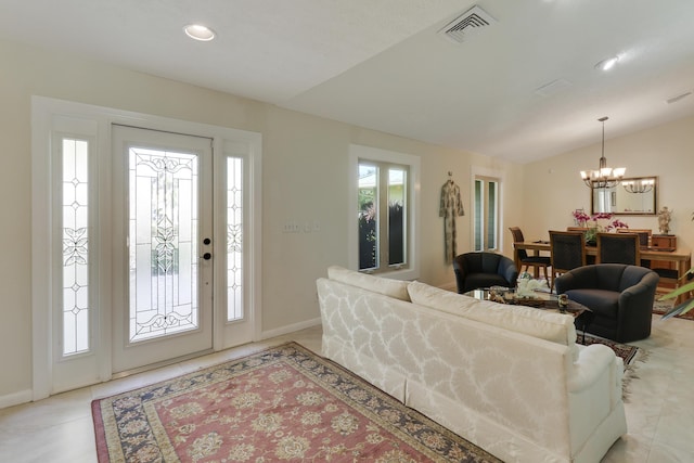 tiled living room featuring lofted ceiling and a notable chandelier