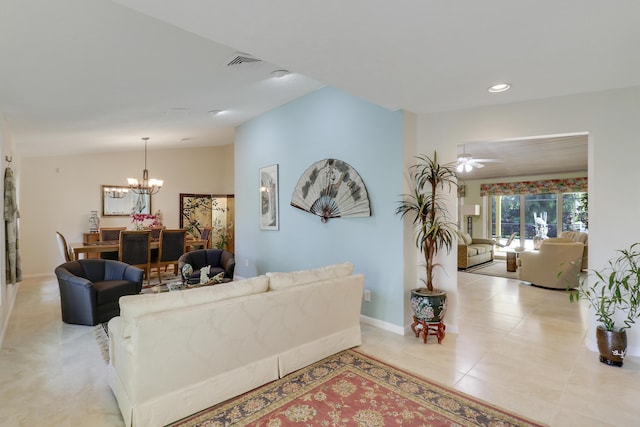 tiled living room with ceiling fan with notable chandelier and lofted ceiling