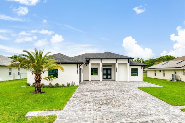 prairie-style house with french doors and a front yard