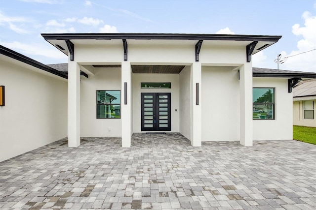 doorway to property with a patio area and french doors