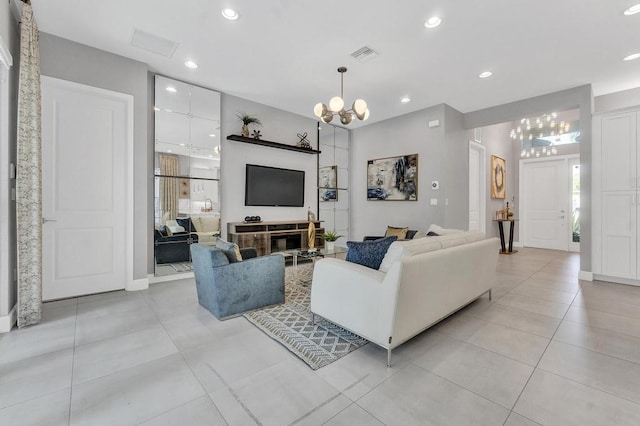 tiled living room with an inviting chandelier