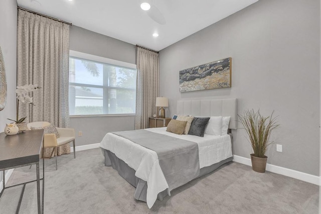 bedroom with ceiling fan and light carpet