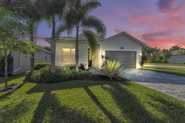 view of front of property with a lawn and a garage