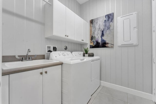 washroom with cabinets, sink, independent washer and dryer, electric panel, and light tile patterned flooring