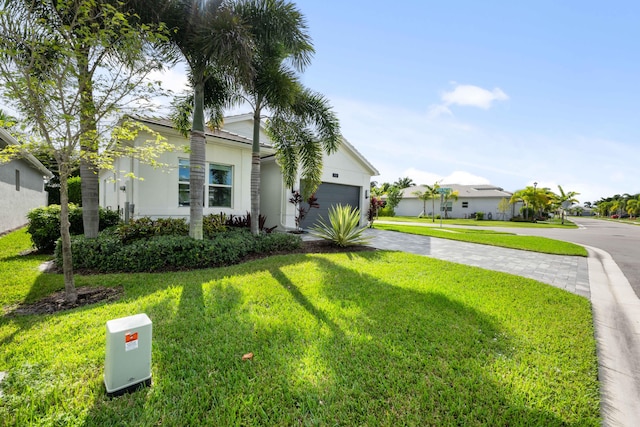 view of front of house featuring a garage and a front lawn