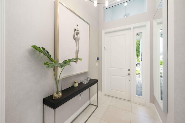 tiled entryway featuring a towering ceiling