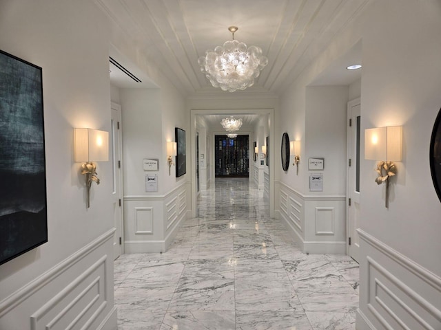 hallway with an inviting chandelier