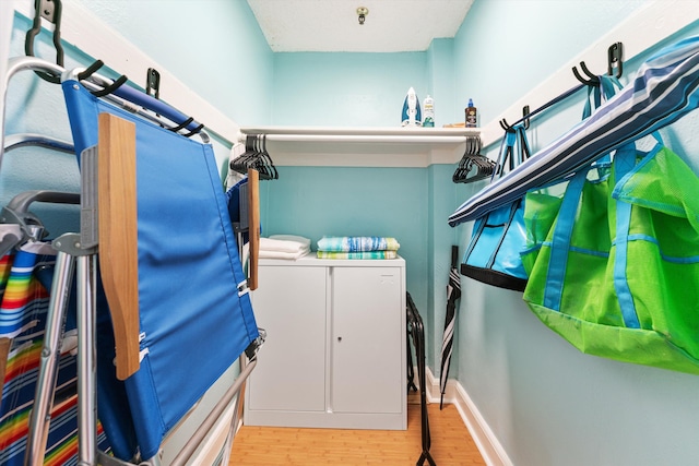 washroom featuring washing machine and dryer and light hardwood / wood-style floors