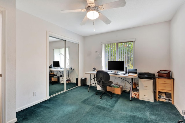 home office with ceiling fan and dark carpet