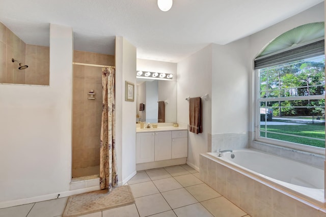 bathroom with tile patterned flooring, vanity, shower with separate bathtub, and a textured ceiling