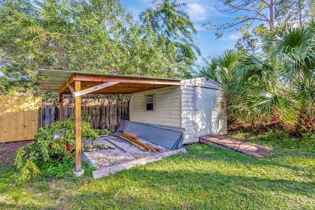 view of outbuilding with a yard and a carport