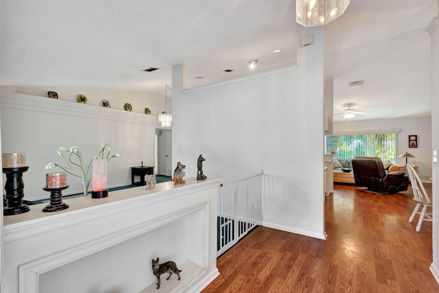 bar featuring ceiling fan, pendant lighting, wood-type flooring, and lofted ceiling