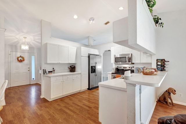 kitchen featuring pendant lighting, white cabinets, light hardwood / wood-style flooring, kitchen peninsula, and stainless steel appliances