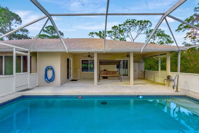 view of swimming pool featuring ceiling fan, a patio area, a lanai, and an outdoor hangout area