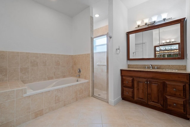 bathroom featuring tile patterned floors, vanity, and shower with separate bathtub