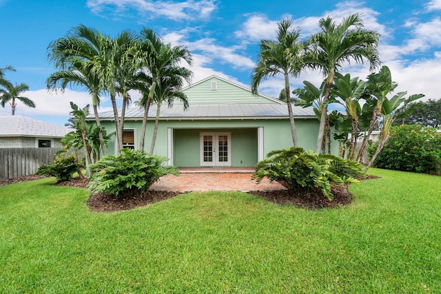 rear view of property with a yard and french doors